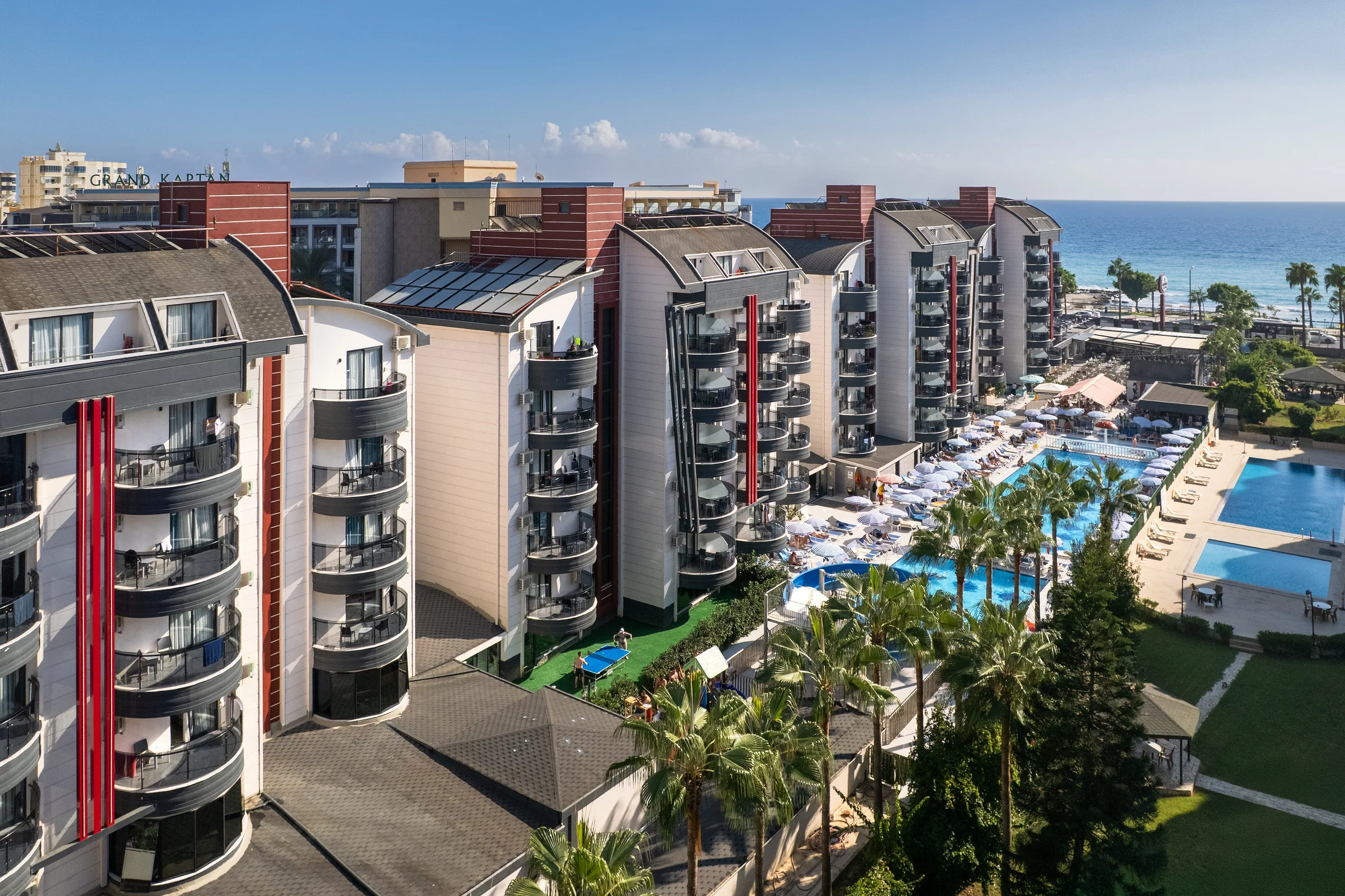 Aerial view of Grand Uysal Beach & Spa Hotel, its pools and the Mediterranean coast